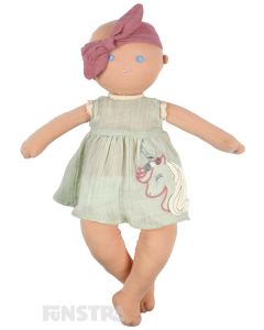 Adorable organic baby doll, Kaia, wears a magical unicorn dress and bow headband with a soft cloth fabric body and weighted bottom.