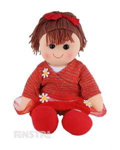 Bella is a beautiful doll with a soft cloth body and brown hair tied in a ponytail with a red bow and wears a red tulle skirt and crossover top embellished with appliqué daisies.