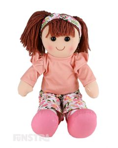 Piper is a funky doll with a soft cloth body and brown hair tied back in pigtails and wears a peach top and floral printed flares and a matching headband.