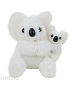Baby koala clings onto mother's back in snowy white fluffy textiles. The koala with baby plush are a symbol of love and affection and these cuddly Aussie creatures are an adorable pair.