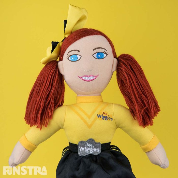A yellow bow, long red hair and wearing her signature yellow shirt and black skirt with the official logo belt buckle.