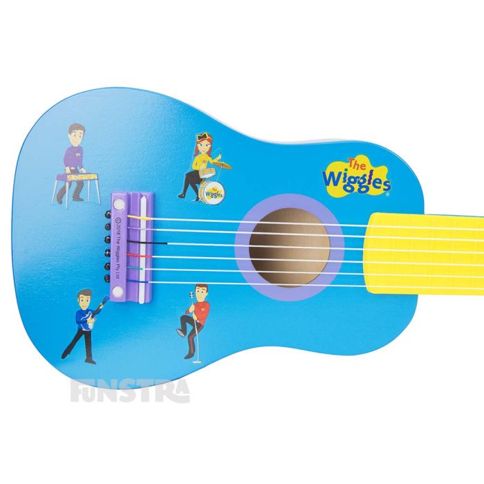 Lachy, Emma, Anthony and Sam are singing and playing musical instruments on the body of the guitar.