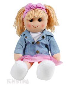 Lottie is a sophisticated doll with a soft cloth body and blonde hair in pigtails with a headband and wears a denim jacket on top of her white top and her pink tulle skirt.