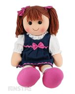 Lacey is a funky doll with a soft cloth body and brown hair tied in pigtails with pink bows and wears a denim dress embellished with pink ribbon and a bow over a white shirt and pink bike shorts.